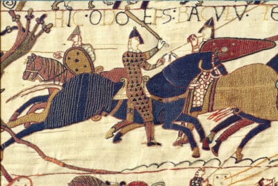 The Bayeux Tapestry (French: Tapisserie de Bayeux [tapisʁi də bajø] or La telle du conquest) is an embroidered cloth nearly 70 metres (230 ft) long and 50 centimetres (20 in) tall that depicts the events leading up to the Norman conquest of England concerning William, Duke of Normandy, and Harold, Earl of Wessex, later King of England, and culminating in the Battle of Hastings. It is thought to date to the 11th century, within a few years after the battle. It tells the story from the point of view of the conquering Normans but is now agreed to have been made in England.
